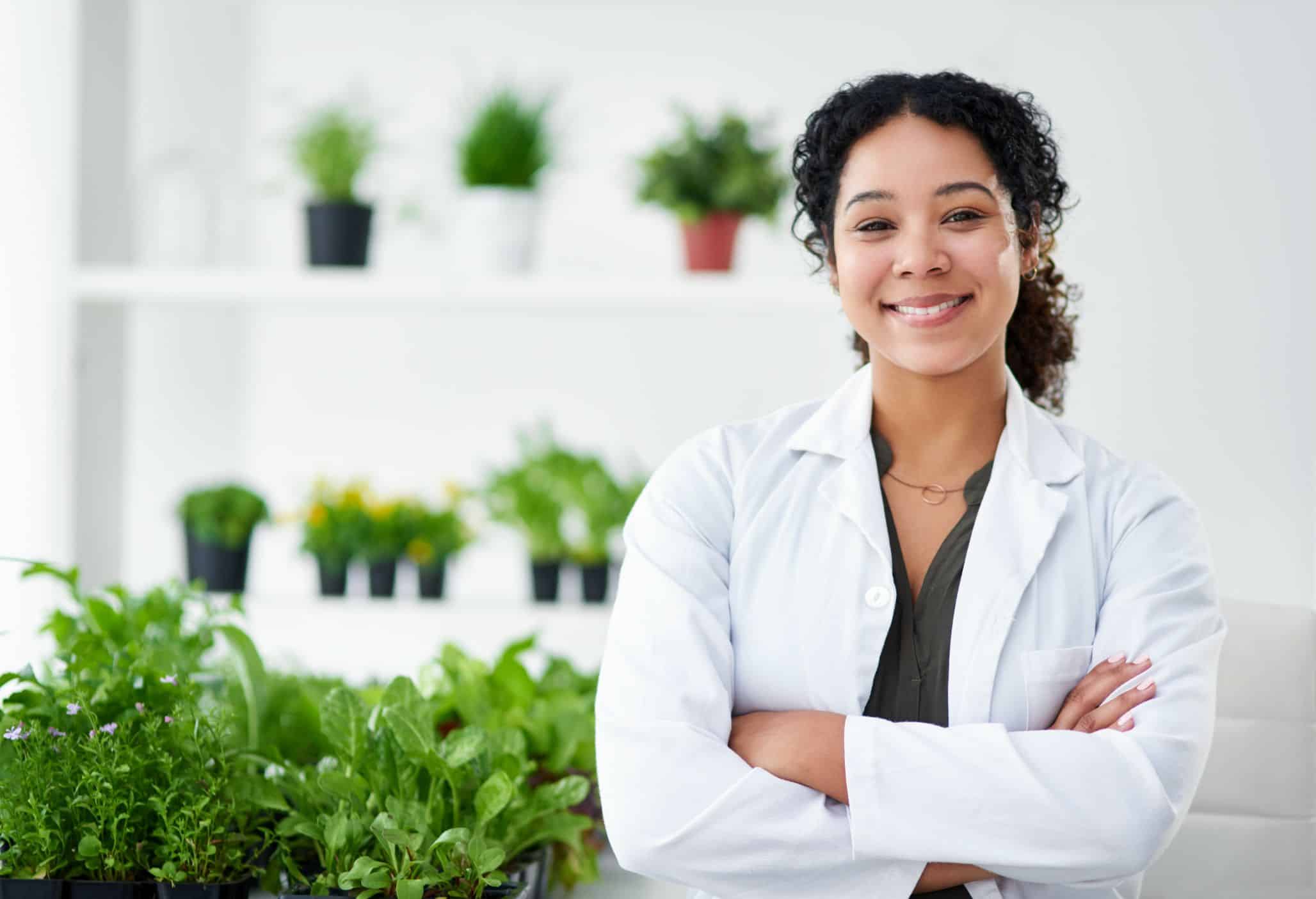 A Naturopath in a room full of nice lush plants.